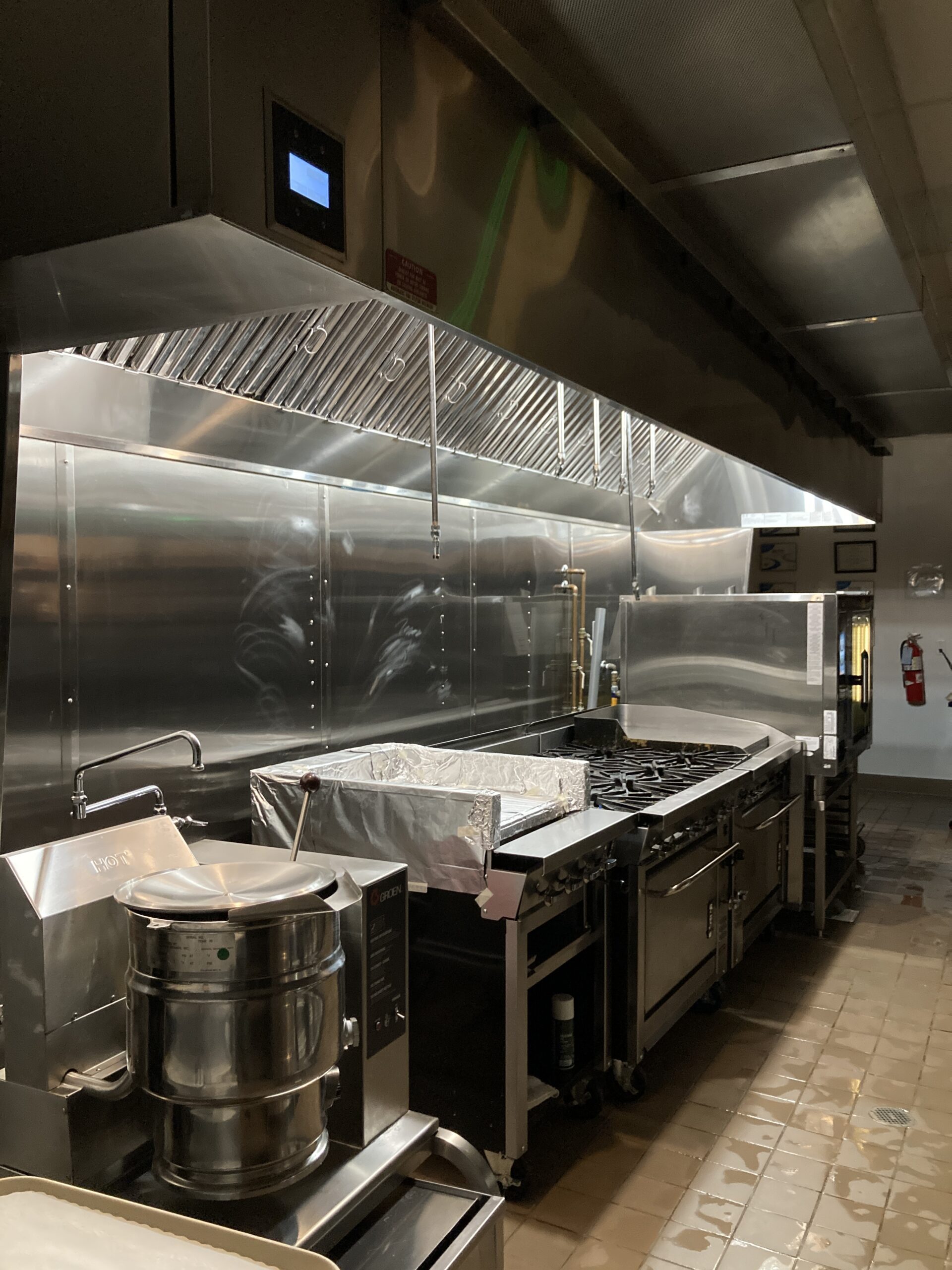 Polished stainless steel exhaust hood in restaurant