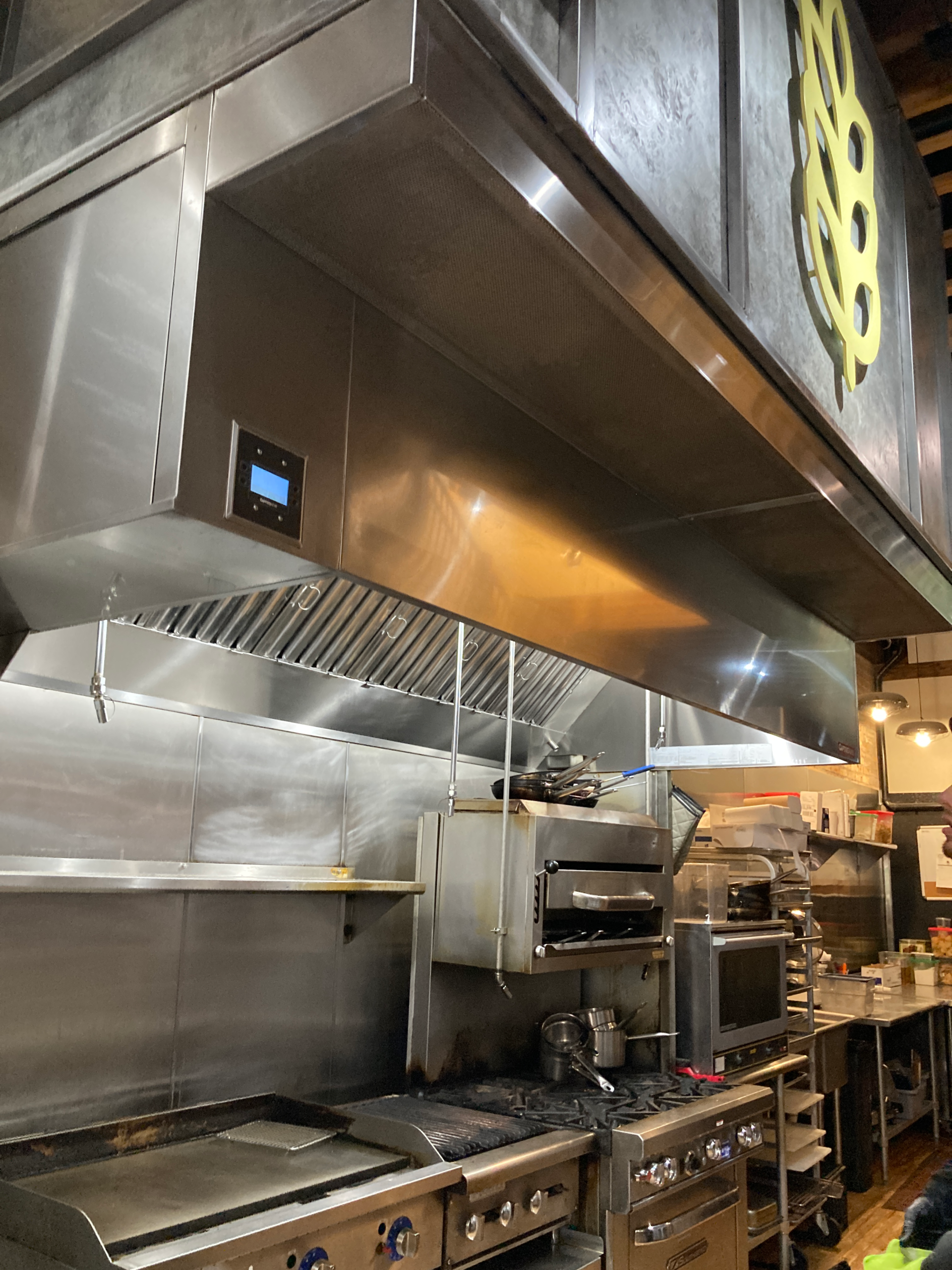 Grease-free commercial hood over cooking equipment
