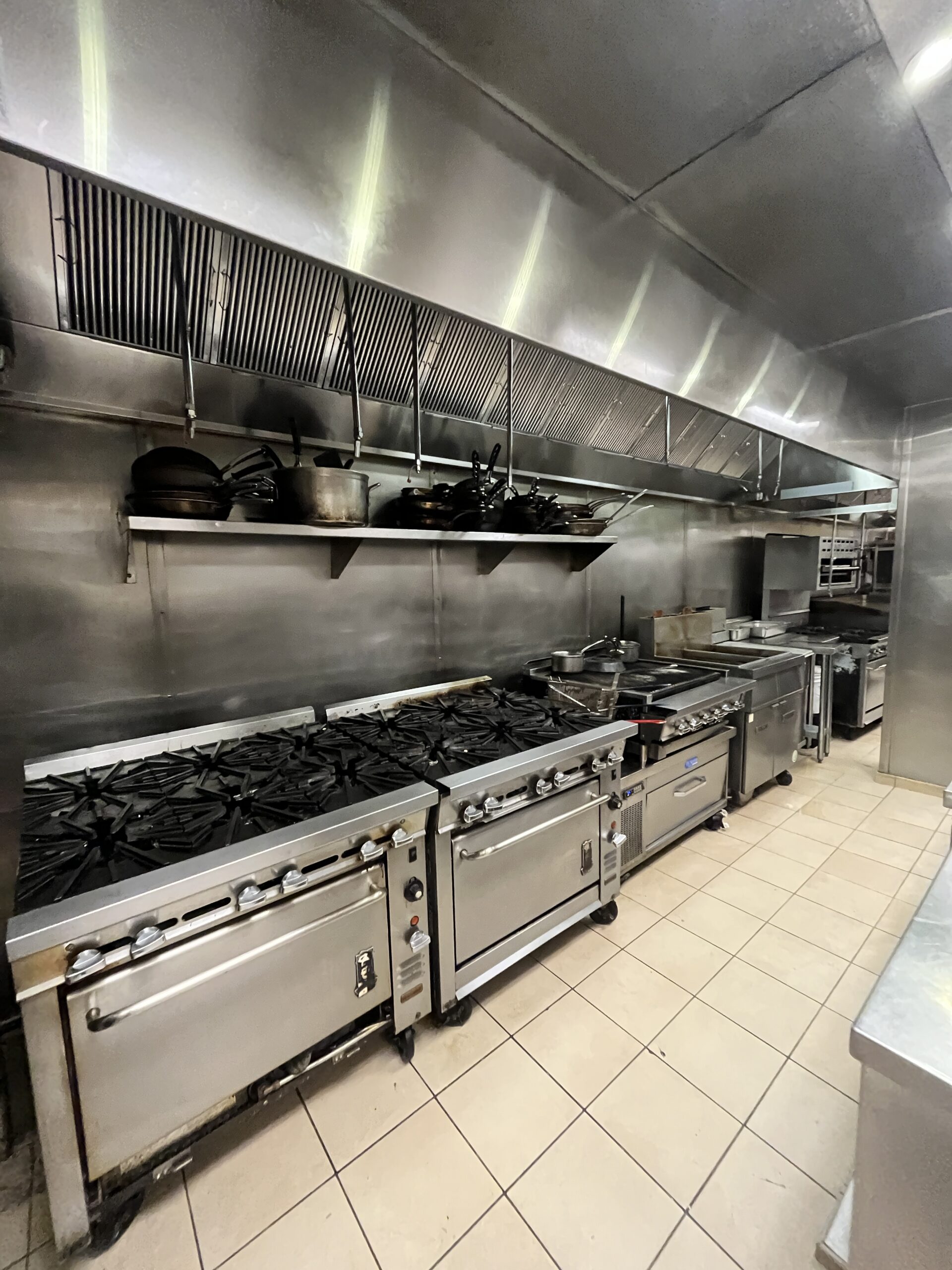 Commercial exhaust hood cleaned above cooking line
